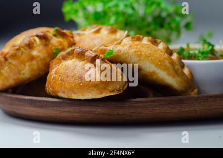 Mini pasties con salsa di pomodoro, suzione di maiale, tacchino, pancetta e mirtillo, il tutto avvolto in pasta frolla, cibo gustoso Foto Stock