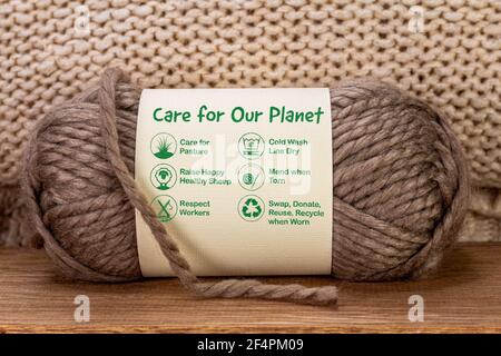 Cura per il nostro pianeta etichetta su palla di lana con icone di cura e testo, la moda sostenibile e consumismo etico Foto Stock