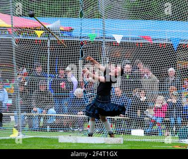 Atleta che si contende nell'evento Hammer Throw al Ballater Highland Games, Aberdeenshire, Scozia. Foto Stock
