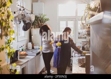 Madre e figlia in guanti di gomma pulizia cucina Foto stock - Alamy