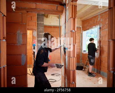 Elettricisti maschi che lavorano nel cantiere Foto Stock