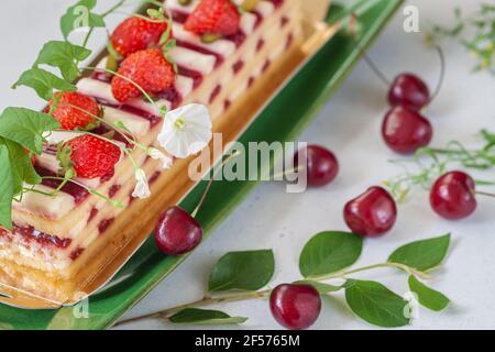 Torta di frutta estiva con fragole, ciliegie mature, colazione romantica. Dieta e vegetarianismo Foto Stock