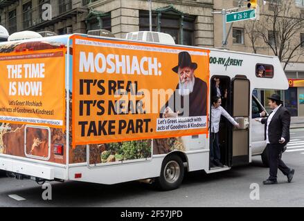 New York, Stati Uniti. 24 Marzo 2021. I membri della comunità di Lubavitcher prendono una pausa dalla loro Parata di passaggio dei carri armati Mitzvah a Chelsea a New York mercoledì 24 marzo 2021. La setta di Lubavitcher degli Hasidim, i adoratori ebrei ultra-ortodossi, continua a fare il loro sproach ai membri decaduti della fede ebraica. La Pasqua inizia la sera di sabato 27 marzo. (ÂPhoto di Richard B. Levine) Credit: Sipa USA/Alamy Live News Foto Stock