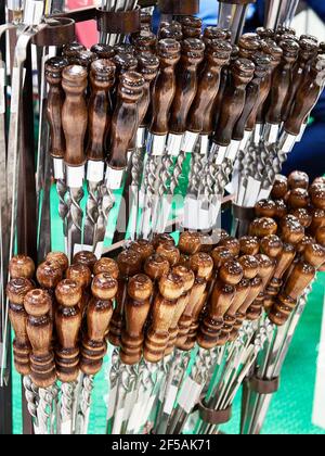 Spiedini di carne con manici in legno nel negozio di articoli per la casa Foto Stock