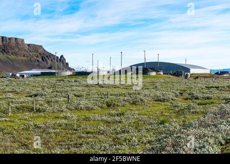 Impianto di trattamento delle acque ai piedi delle colline rocciose una giornata estiva parzialmente nuvolosa Foto Stock