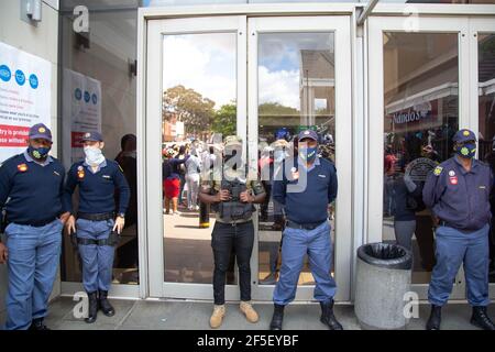 Johannesburg, Sudafrica. 26 Marzo 2021. La polizia e la sicurezza si levano in guardia durante una protesta. I manifestanti si sono riuniti fuori dal Boulders Shopping Centre a Midrand, in Sud Africa, in reazione ad un manager che ha affrontato un uomo vestito con la tradizionale abbigliamento Ndebele e gli ha chiesto di lasciare un negozio Clicks nel centro commerciale. Credit: SOPA Images Limited/Alamy Live News Foto Stock