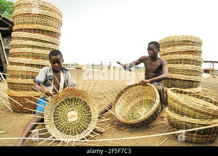 I bambini nigeriani tessono cesti nella periferia dello Stato di Ondo, Nigeria. Foto Stock