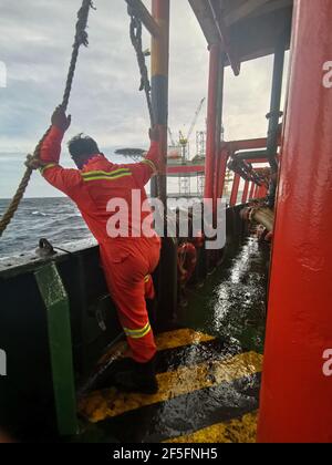 la nave di rifornimento offshore si avvicina lentamente alla macchina petrolifera durante la zona di 500 metri alla macchina petrolifera per la fornitura di carichi Foto Stock