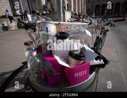 Monaco, Germania. 26 Marzo 2021. I contenitori pieni di rifiuti traboccano mentre i passanti si siedono sui gradini dell'Opera di Stato bavarese su Max-Joseph-Platz. Credit: Peter Kneffel/dpa/Alamy Live News Foto Stock