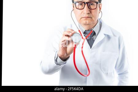 Medico latino in cappotto bianco e occhiali guardando la macchina fotografica con uno stetoscopio rosso per ascoltare il cuore o i polmoni. Concetto di medicina e cura del cuore Foto Stock