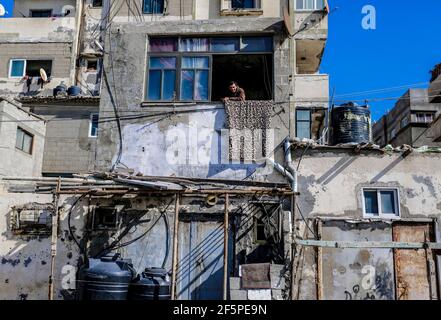 Gaza, la striscia di Gaza, la Palestina. 27 Marzo 2021. Un uomo palestinese si trova alla finestra della sua casa nel campo profughi di Shati, nella striscia occidentale di Gaza. Credit: Mahmoud Issa/Quds Net News/ZUMA Wire/Alamy Live News Foto Stock