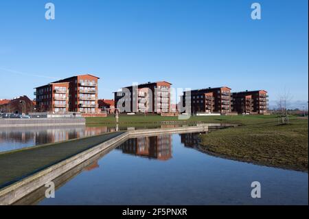 Quattro edifici di appartamenti identici e moderni in mattoni rossi che si trovano vicino alla a lago di Lund Svezia Foto Stock