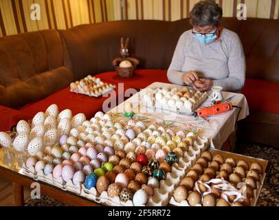 Praga, Repubblica Ceca. 27 Marzo 2021. Una donna decora un uovo di Pasqua nel villaggio di Cisovice, Repubblica Ceca, 27 marzo 2021. Le donne locali in campagna gradiscono verniciare le uova di Pasqua prima della festa e dare loro ad altri come regali. Credit: Dana Kesnerova/Xinhua/Alamy Live News Foto Stock