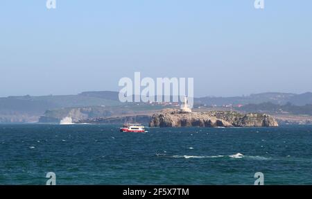 Regina traghetto turistico barca passando di fronte a Mouro Island su mari accidentati in un ventoso pomeriggio di primavera Santander Cantabria Spagna Foto Stock