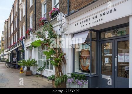 Vista dei fronti dello shopping con colorate vetrine in Blandford Street, Marylebone, Londra, Inghilterra, Regno Unito Foto Stock