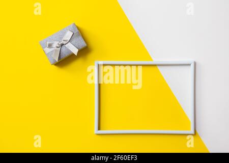 Cornice fotografica vuota per il testo su carta geometrica bianca e gialla. Foto Stock