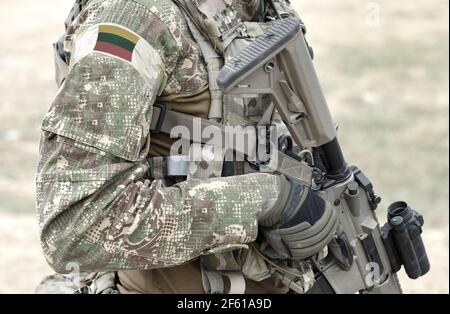 Soldato con fucile d'assalto e bandiera della Lituania su uniforme militare. Collage. Foto Stock