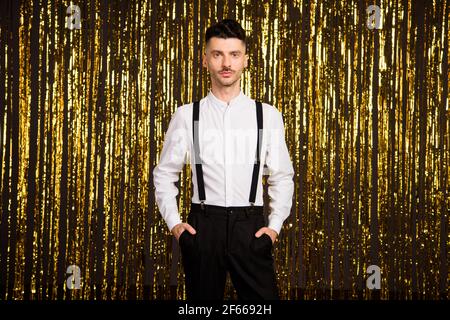 Foto di un giovane bell'uomo sicuro e serio in tasca festa di formalwear isolato su sfondo di colore glitter Foto Stock