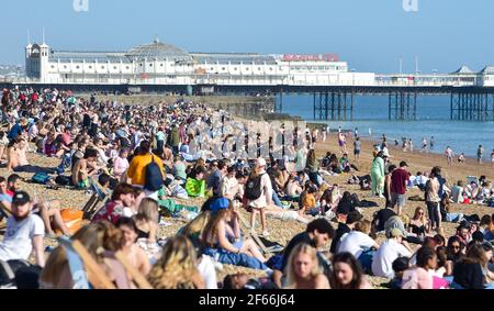 Brighton UK 30 marzo 2021 - Brighton Beach è piena di visitatori che affollano il mare il giorno più caldo dell'anno, con temperature che raggiungono la metà degli anni '20 centigradi in alcune parti del Sud Est: Credit Simon Dack / Alamy Live News Foto Stock