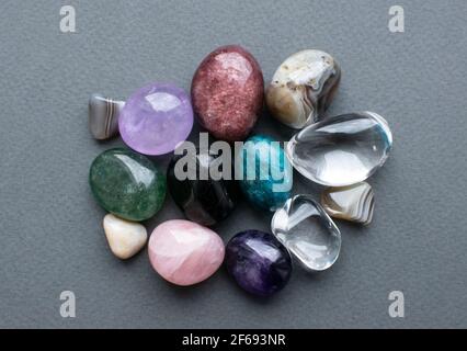 Gemme tumbled di vari colori. Ametista, quarzo rosa, agato, apatite, aventurina, olivina, turchese, cristallo di roccia. Foto Stock