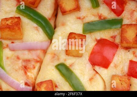 Pizza Paneer Makhani , deliziosa pizza fatta in casa con peperone rosso e verde, cipolla, mozzarella e fette di pasta frolla, closeu Foto Stock