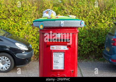 Bromsgrove, Worcs, Regno Unito. 31 Marzo 2021. Due caselle postali Royal Mail sono state improvvisamente misteriosamente decorate con graziose coperte a tema primaverile nella zona Catshill di Bromsgrove, Worcs. Le coperture graziose hanno pulcini, coniglietti e fiori che li adornano ed hanno un'etichetta calda e amichevole del messaggio fissata. Sembra che un gruppo Facebook di artigiani chochet chiamato Random atti di gentilezza crochet sono dietro il gesto. Altre caselle postali che sono state coperte allo stesso modo sono a Battersea, Lincoln e Galles. Credit: Peter Lopeman/Alamy Live News Foto Stock