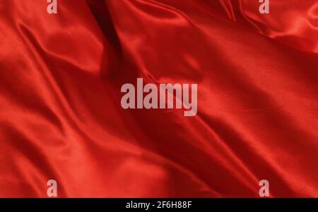 Fondo astratto seta rossa e arancione o tessuto di lusso satinato texture Foto Stock