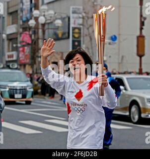 Città di Isezaki, Giappone. 30 Marzo 2021. NESSUNA VENDITA IN GIAPPONE! Il lanciatore della torcia corre con la torcia olimpica attraverso la città di Isezaki, Isesaki, relè della torcia, fiamma olimpica, fiamma, Relè goalch, ridendo, sventolando, Giochi Olimpici estivi 2020 a Tokyo/Giappone, si terrà a Tokyo dal 23 luglio all'8 agosto 2021, NESSUNA VENDITA IN GIAPPONE! | utilizzo in tutto il mondo credito: dpa/Alamy Live News Foto Stock