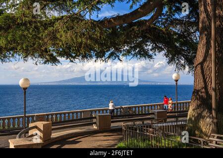 Una vista del vulcano Vesuvio attraverso il Golfo di Napoli da un parco di Sorrento, Campania, Italia Foto Stock