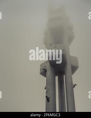 Torre della televisione di Zizkov - Žižkovská věž - con sculture di 'Babies' (Miminka) di David Cerny in un giorno misteriosa; Torre della TV di Žižkov a Mahlerovy Sady, Praga Foto Stock