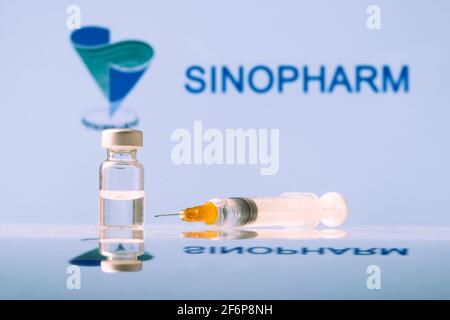 Flaconcino e siringa di vaccino Sinopharm Coronavirus con logo come sfondo. LUBIANA, SLOVENIA: 25 marzo 2021 Foto Stock