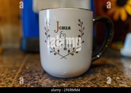 Gesù e tazza di caffè su un piano di piastrelle Foto Stock