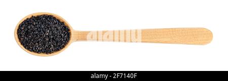 asciugare i semi di sesamo nero in un cucchiaio di legno Foto Stock