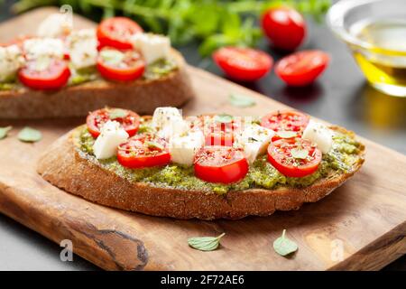 Antipasti di bruschette con pesto e mozzarella di ciliegia tomatos Foto Stock