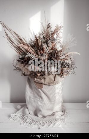 Composizione alla moda di fiori secchi, arredamento per la casa, un dono duraturo di fiori ed erbe. Foto Stock