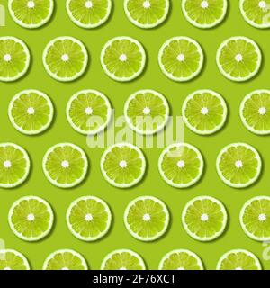 Sfondo vivace con fette di calce verde su sfondo verde. Struttura e modello di cibo piatto minimo Foto Stock