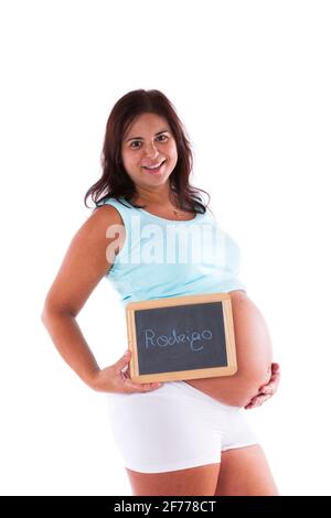 Donna incinta che mostra il nome del bambino Foto Stock