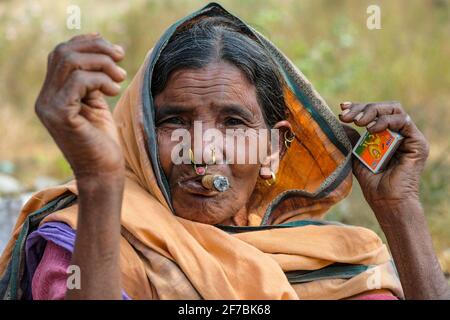 Chatikona, India - 2021 febbraio: Una donna Adivasi della tribù Desia Kondh che fuma nel mercato di Chatikona il 17 febbraio 2021 a Odisha, India. Foto Stock