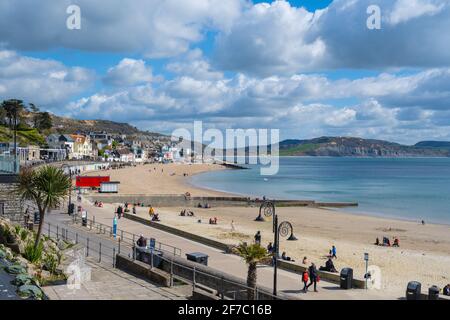 Lyme Regis, Dorset, Regno Unito. 6 Apr 2021. Regno Unito Meteo: Luminoso e soleggiato con una fresca brezza presso la località balneare di Lyme Regis. Il pittoresco resort sulla Costa Sud gode di un inizio luminoso e soleggiato mentre molte parti del Regno Unito si svegliano con una coperta di neve. La spiaggia era oggi molto più tranquilla nonostante le condizioni luminose dovute alla fresca brezza. Credit: Celia McMahon/Alamy Live News Foto Stock