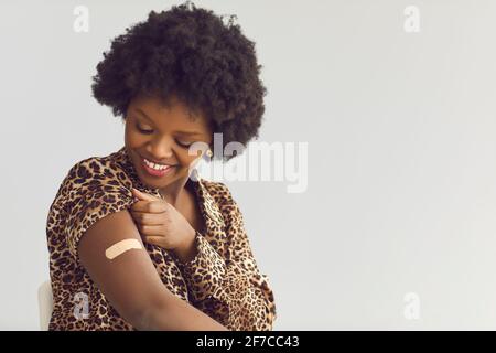 Felice sorridente soddisfatta donna afroamericana ottenendo covid19 vaccino ritratto Foto Stock