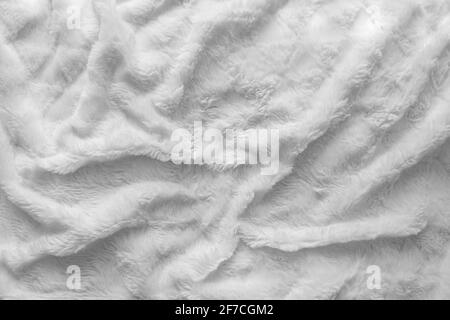 Soffice e soffice coperta bianca, copriletto. Texture shaggy. Tessuto ad alta consistenza in pelo Foto Stock