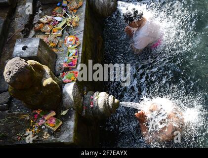 I balinesi si purificano al bagno purificante del tempio Tirta Empowerl di Bali, Indonesia. Foto Stock