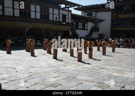 Danza ballerini Masquerade Ball Parade Monastery Performance Donne Dancing with Maschere Danza tradizionale della creazione Regno del Bhutan Himalaya Foto Stock