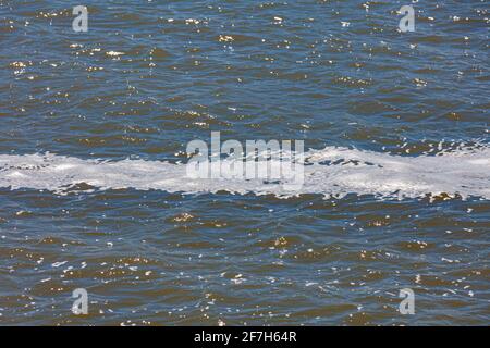 Immagine astratta di una striscia di schiuma su un fiume durante Una tempesta di vento a Steveston British Columbia Canada Foto Stock