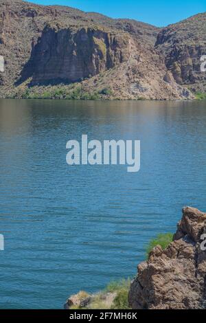 Splendide formazioni rocciose nel deserto fiancheggiano questo appartato lago Canyon a Tortilla Flat, Tonto National Forest, Arizona Foto Stock