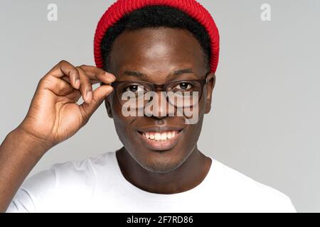 Closeup ritratto di giovane hipster africano con ampio toothy sorriso isolato su sfondo bianco Foto Stock