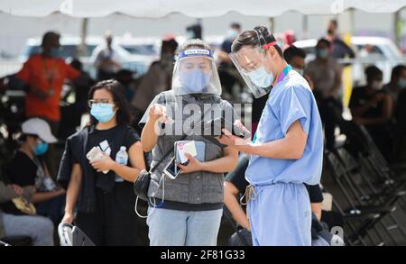 Toronto, Canada. 10 Apr 2021. Un medico controlla le informazioni per una donna in una clinica vaccinale COVID-19 a Toronto, Canada, il 10 aprile 2021. A partire da sabato pomeriggio, il Canada ha segnalato 5,986 nuovi casi di COVID-19, portando il totale cumulativo a 1,051,246, di cui 23,282 morti, secondo CTV. Credit: Zou Zheng/Xinhua/Alamy Live News Foto Stock