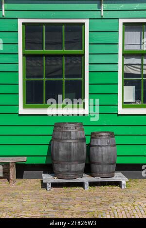 Botti di legno di fronte ad una casa di legno verde a Zaanse Schans, Paesi Bassi Foto Stock