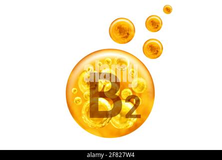 Capsula di vitamina B2. Palline d'oro con bolle isolate su sfondo bianco. Concetto di stile di vita sano. Foto Stock