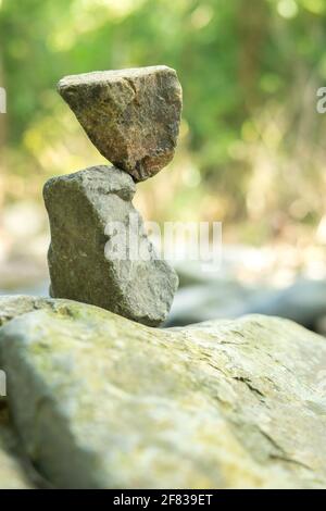 Rocce accatastate accanto al torrente nella foresta Foto Stock